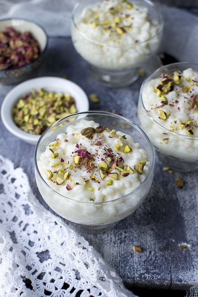 three small bowls filled with food on top of a table