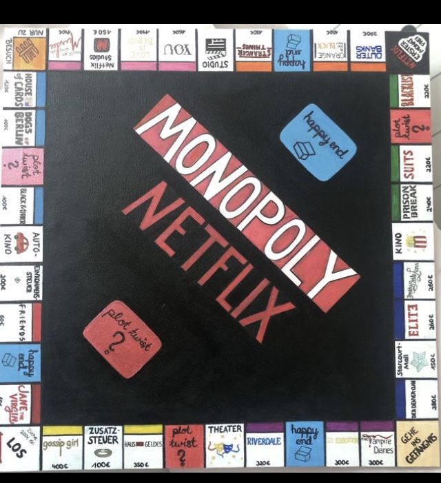 a close up of a monopoly board game with words on it and stickers all over the board