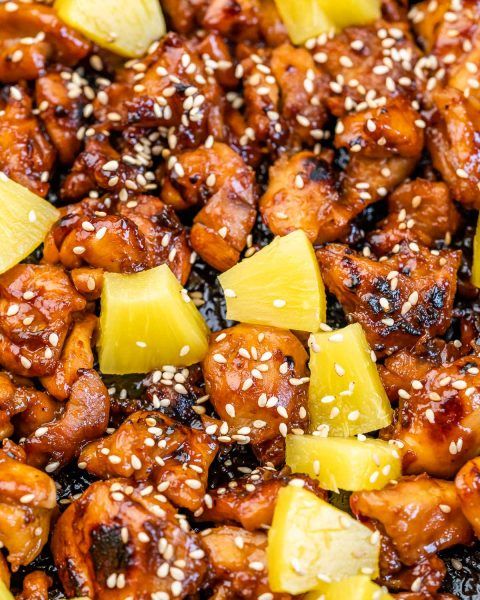 chicken with pineapples and sesame seeds in a skillet, ready to be eaten