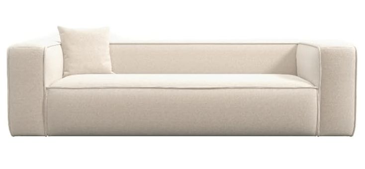 a white couch with two pillows on it