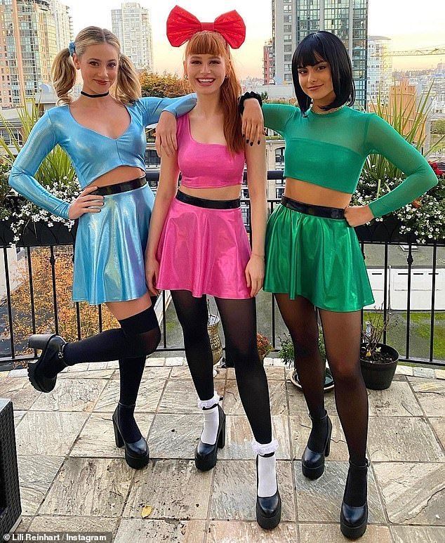 three young women dressed in costumes posing for the camera