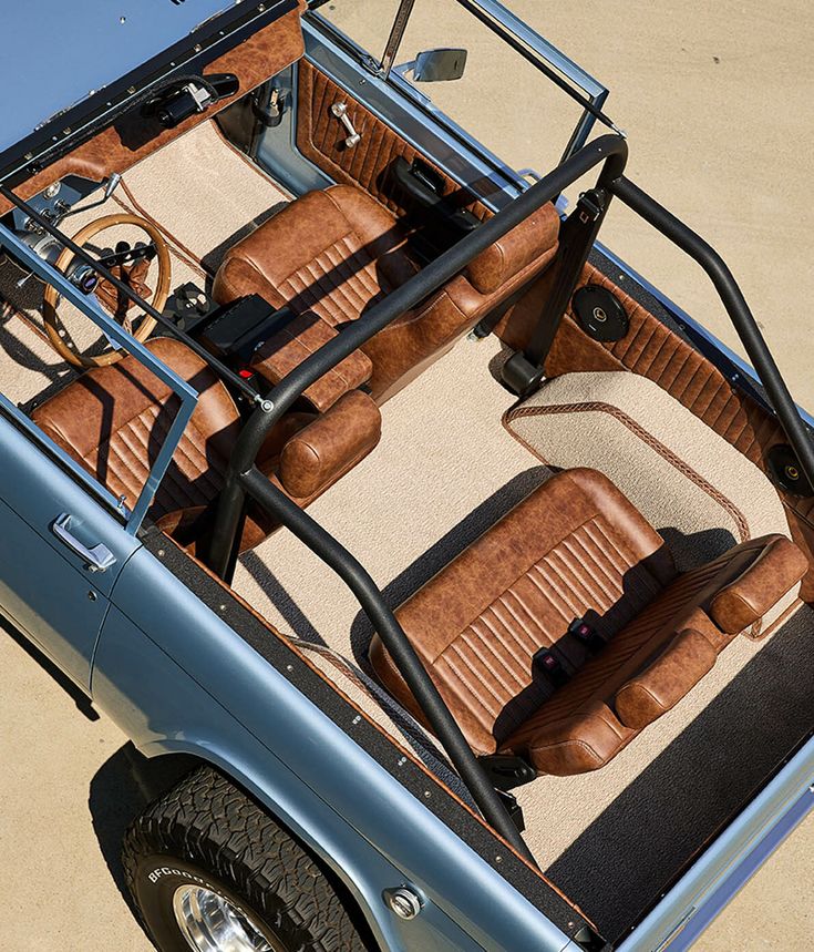 the interior of an older model car with leather seats and steering wheel arch, viewed from above