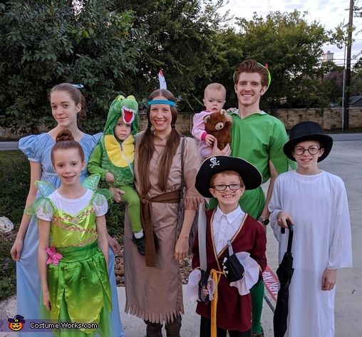 a group of people in costumes posing for a photo