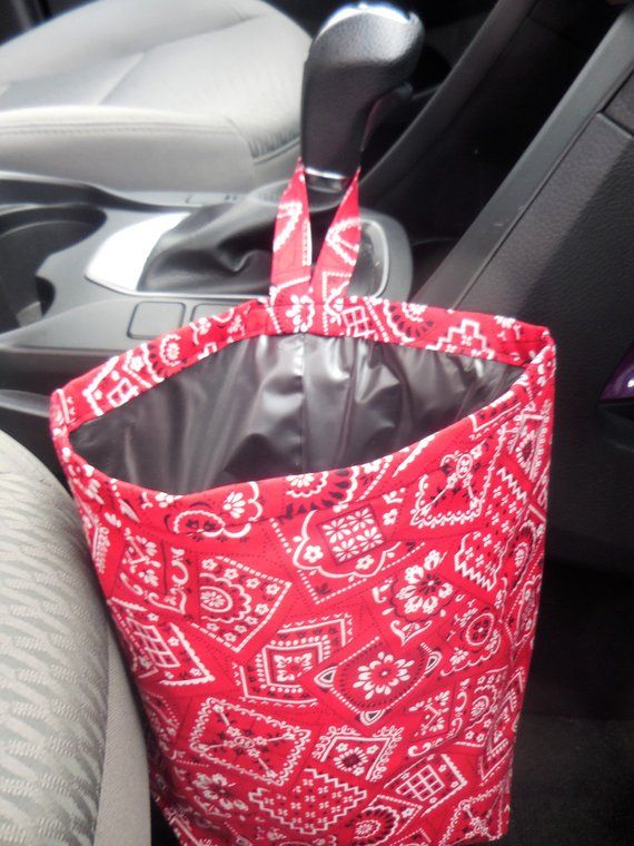 a red and white bag sitting in the back seat of a car