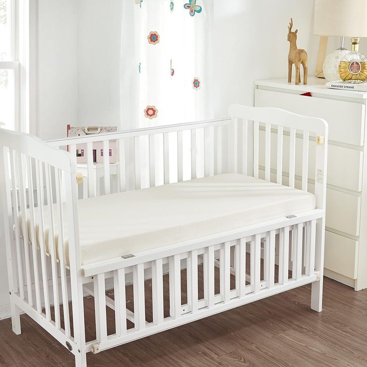 a white crib in the corner of a room