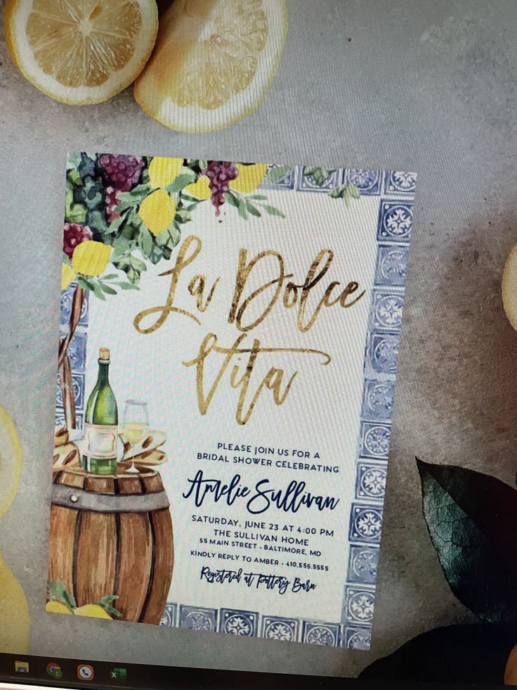 a wine themed wedding card with lemons and grapefruits on the table