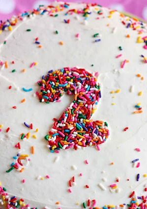 a birthday cake with sprinkles and the number two on it's frosting