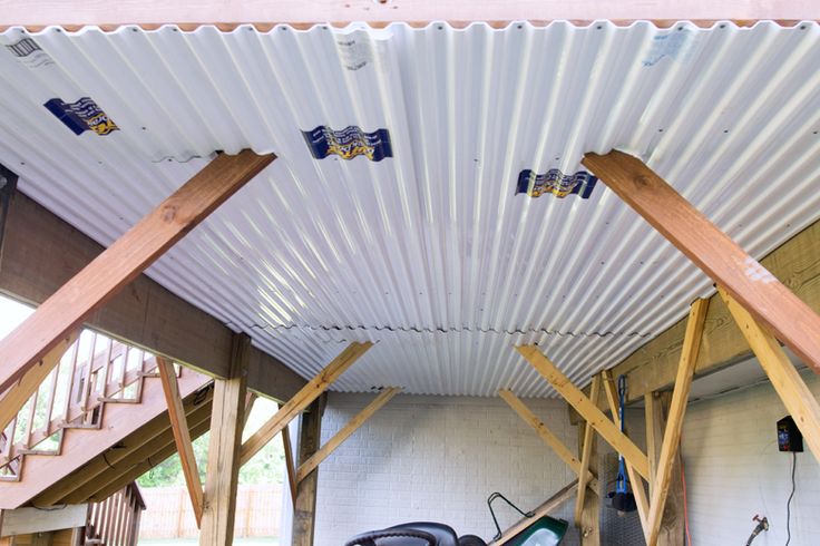 the inside of a building with some tools in it and wood beams on the ceiling