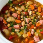 a white bowl filled with soup and vegetables