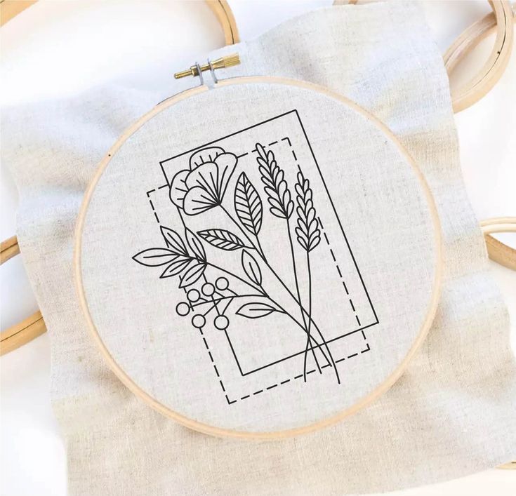 a cross stitch pattern with flowers and leaves on the front is shown in black ink