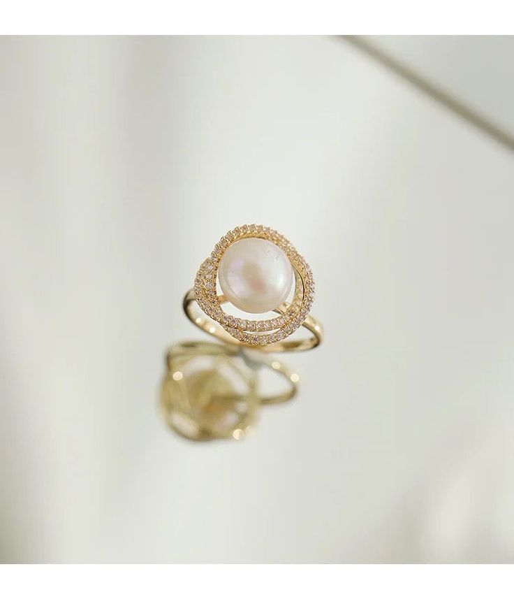 Live your vintage inspired dreams with our pearl and diamond ring. With the pearl bead in the middle and CZ Diamonds surrounding this is the perfect romantic gift for an engagement ring.• Material: High Quality 14K Gold Plated• Finish: 14K Gold Luxury Oval Pearl Ring, Elegant Oval Pearl Ring With Diamond Accents, Elegant Diamond Pearl Promise Ring, Elegant Diamond Pearl Ring For Promise, Elegant Oval Pearl Drop Rings, Elegant Oval Rings With Pearl Drop, Elegant Akoya Pearl Oval Rings, Elegant Oval Akoya Pearl Rings, Elegant Gold Pearl Ring For Wedding