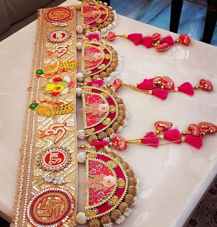 a table topped with lots of different types of necklaces and bracelets on top of it