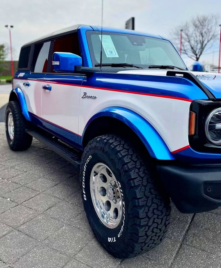 a blue and white truck parked in a parking lot