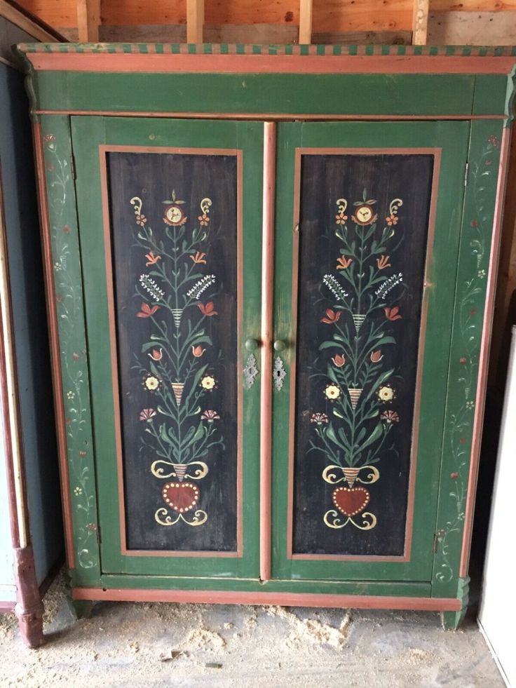 an old painted armoire with flowers on it