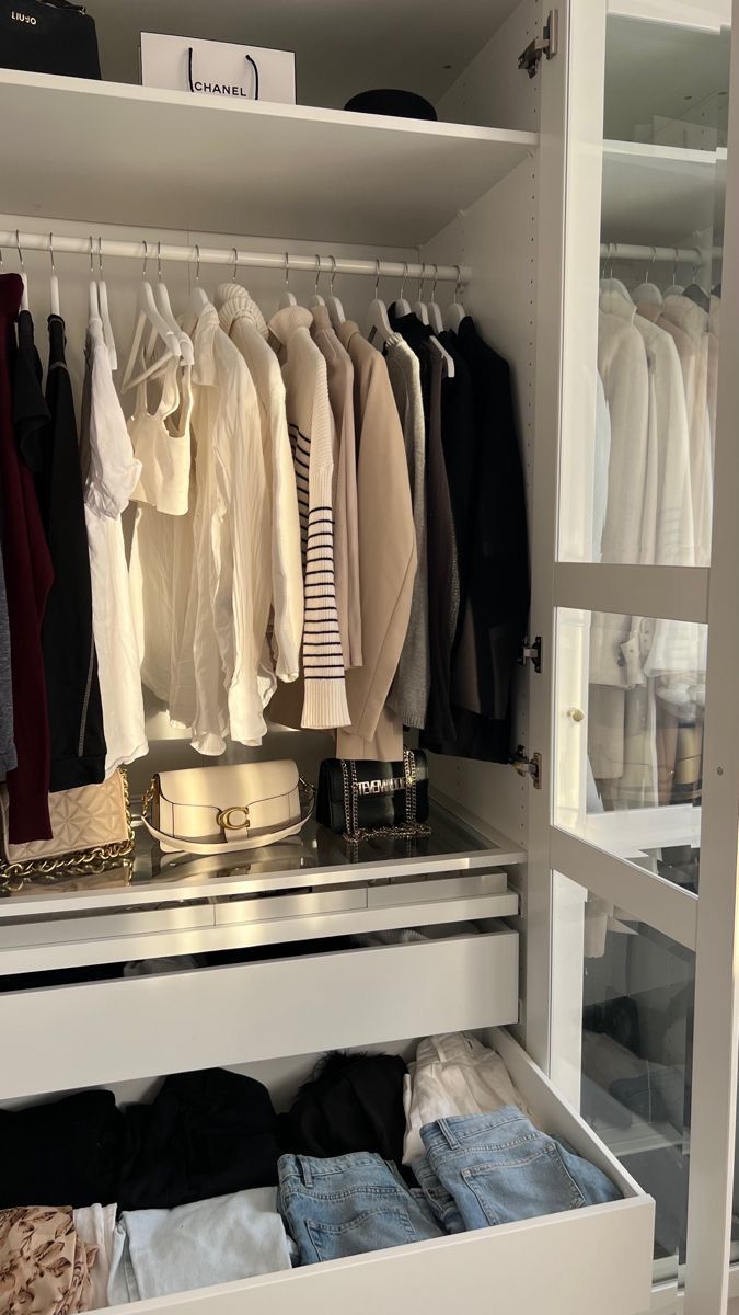 an organized closet with clothes and other items