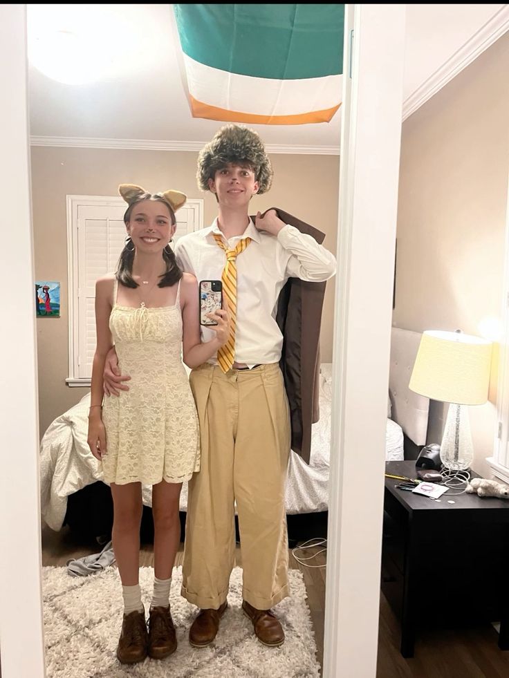 a young man and woman are standing in the doorway to their bedroom, posing for a photo