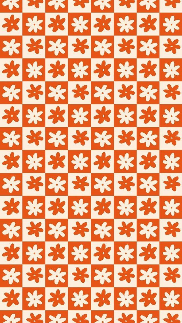 an orange and white pattern with flowers on it