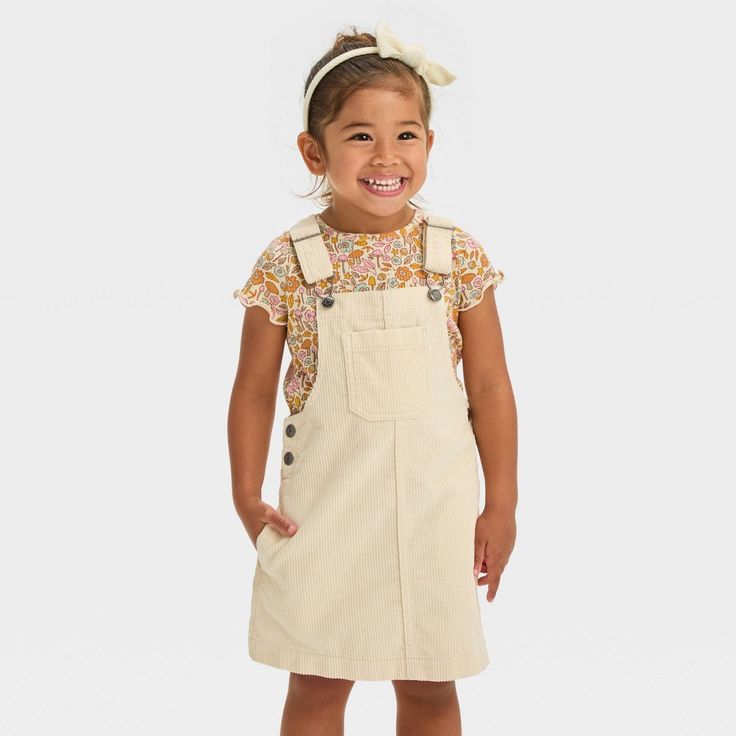 Elevate your child's casual style with this Sleeveless Mini Skirtall from Cat & Jack™. Made from cotton corduroy fabric with lining for comfortable wear, this sleeveless shirtall in a cream hue features a V-back design for laid-back style. The front and side pockets provide ample space to stash small items, while the adjustable shoulder straps with buckles offer a custom fit and the side snap buttons allow for easy on and off. Cat & Jack™: Designed for all children so you can trust it's made for Dresses For Toddlers, Toddler Fall Dress, Solid Jumpsuit, Toddler Fall, Long Sleeve Knit Dress, Long Sleeve Print Dress, Girls Denim, Light Blue Denim, Girls Long Sleeve