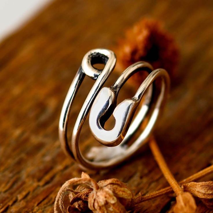 Make a bold statement with this stylish Safety Pin Ring, made of sterling silver. The iconic safety pin shape gives this ring a modern and edgy look, making it the perfect choice for anyone looking to add a touch of attitude to their everyday style. In addition to its stylish design, the safety pin symbolizes resilience and solidarity, making this Safety Pin Ring a meaningful accessory for those who embrace individuality and strive for unity.Material: Genuine Sterling Silver 92.5Ring size: Choos Safety Pin Rings, Rings With Safety Pin, Safety Pin Ring, Gold Safety Pin Shaped Brooch Jewelry, Gold Safety Pin Shaped Brooch, Steampunk Safety-pin Jewelry, Moonstone Ring Sterling Silver, Wellness Gifts, Edgy Look