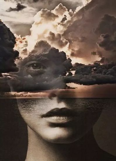 a woman's face with clouds in the sky above her and water below it