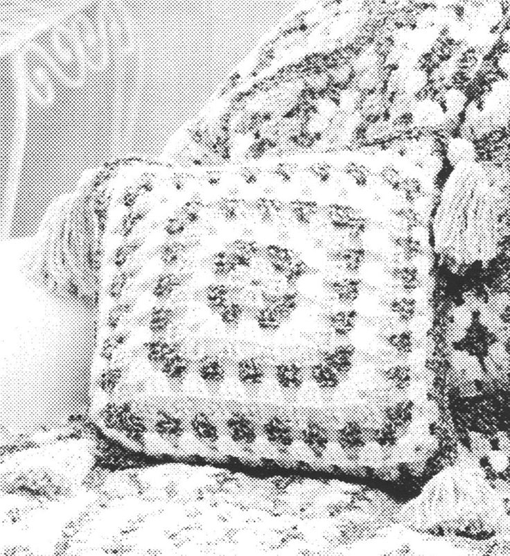 an old black and white photo of a couch with two pillows on top of it