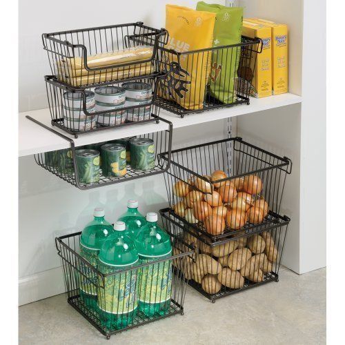 three metal baskets filled with food on top of a white shelf