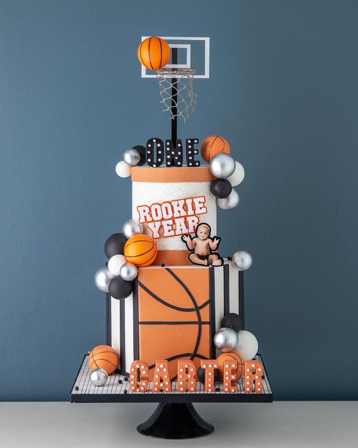 a three tiered cake with basketball decorations on it