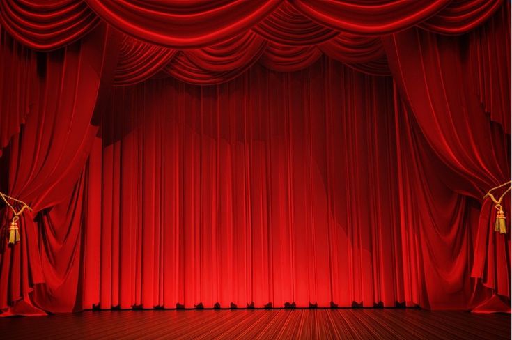 an empty stage with red curtains and gold tassels