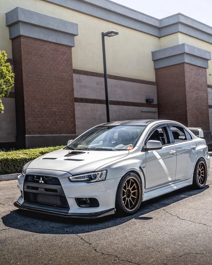 a white car parked in front of a building