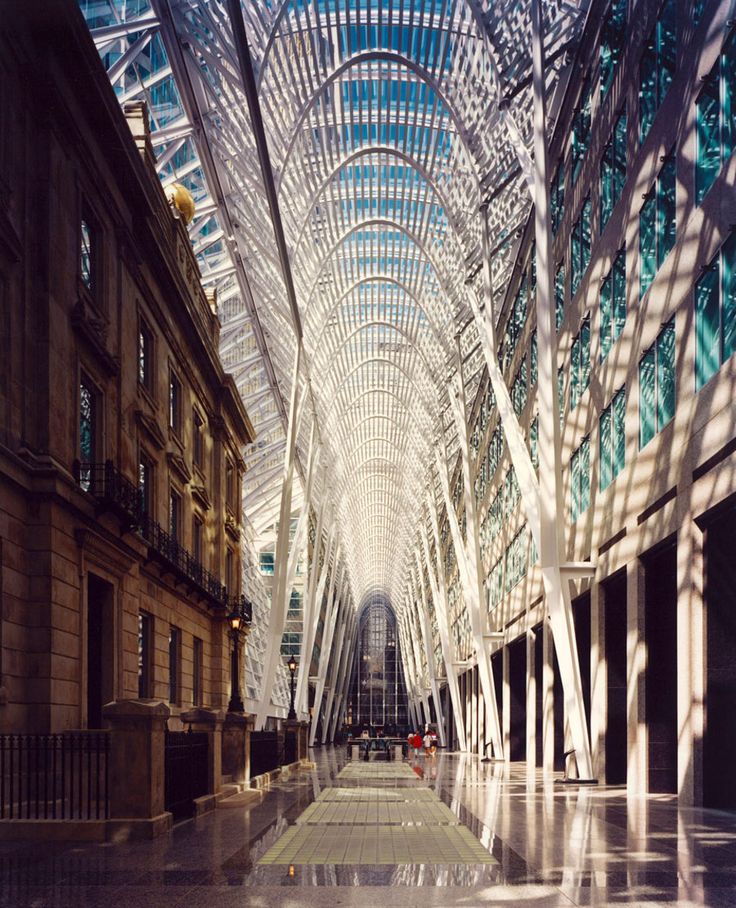 the inside of a large building with many windows and glass covering it's ceiling