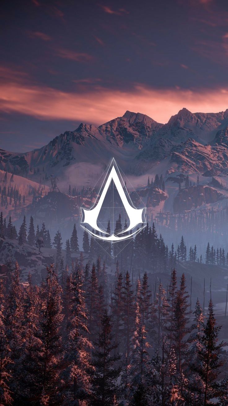 an image of the elder scrolls logo in front of mountains and trees with fog over them