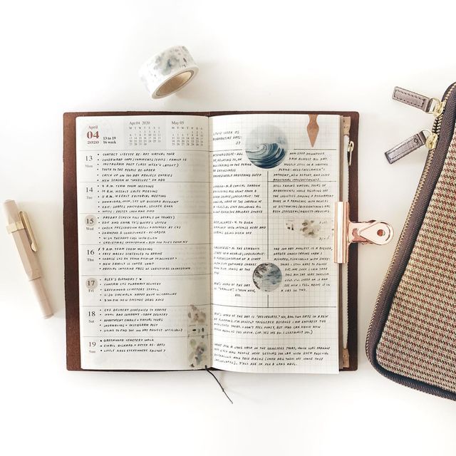 an open book sitting on top of a table next to a pair of scissors and tape