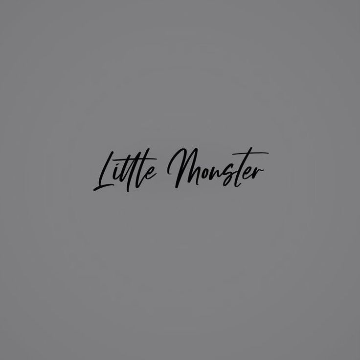 the word little monster written in black ink on a gray background with an arrow pointing to it