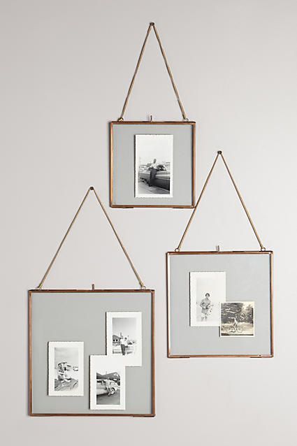 three hanging frames with pictures on them