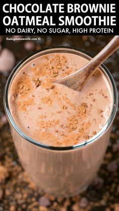 chocolate brownie oatmeal smoothie in a glass with a wooden spoon