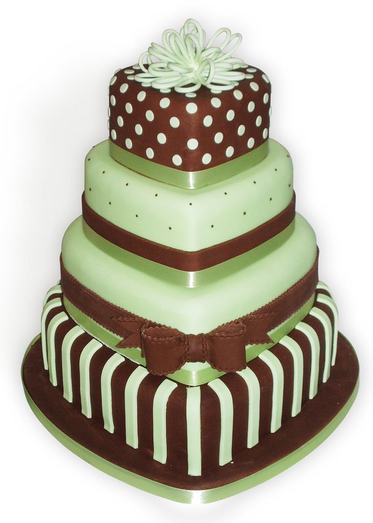 a three tiered cake with polka dots and stripes on the top, decorated in green and brown