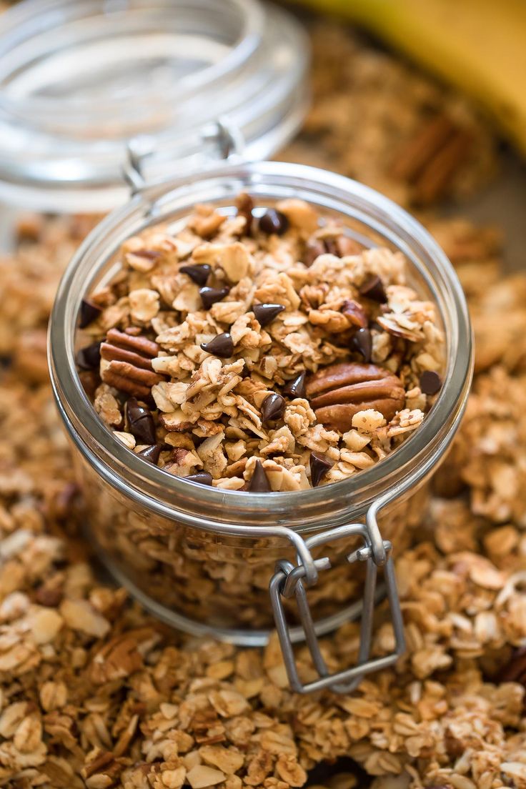 a glass jar filled with granola on top of a table