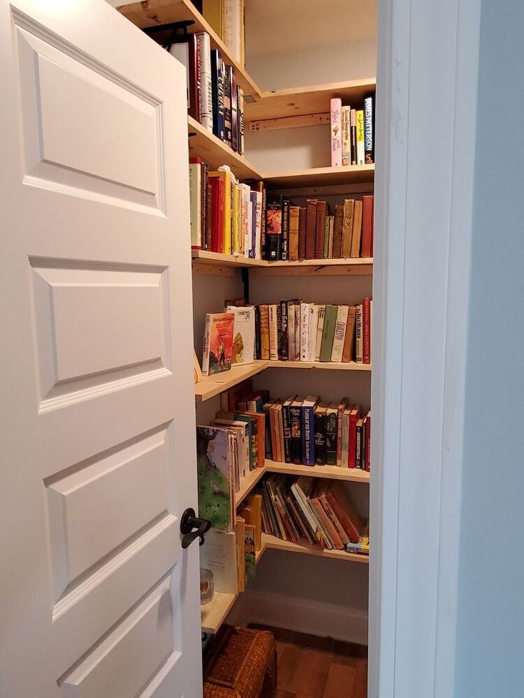 an open door to a book shelf filled with books