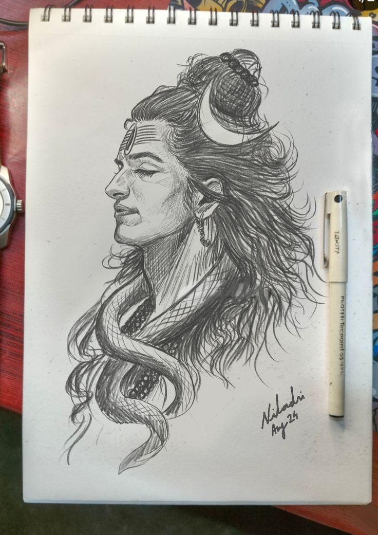 a drawing of a native american woman with her hair blowing in the wind, on top of a spiral notebook