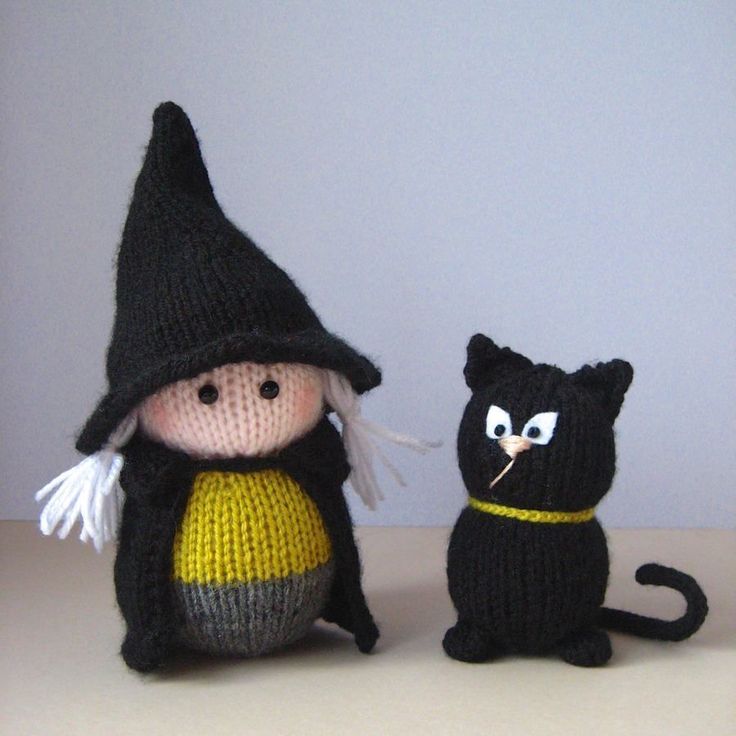 two small knitted dolls sitting next to each other