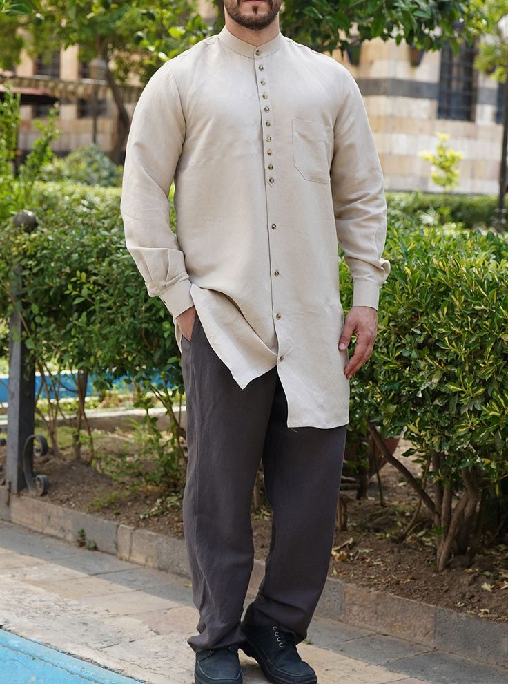 Buttoned mandarin collar Multiple button neck opening and regular buttoned lower opening Arabesque style metallic shank buttons Buttoned cuffs with pleats Left breast pocket Model is 184cm (6 feet) and wearing size L. Item Code: mQ1082 Elegant Long Sleeve Kurta With Button Cuffs, Formal Long Sleeve Kurta With Buttons, Classic Long Sleeve Kurta With Buttons, Casual Long Sleeve Kurta With Button Cuffs, Elegant Long Sleeve Kurta With Button Closure, Surf Spray, Modern Clothes, Islamic Clothing, Pocket Model