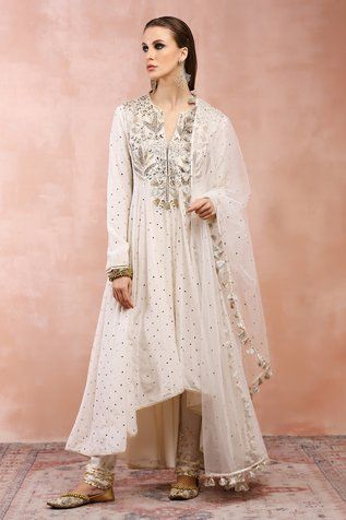 Off-white anarkali with mukaish, thread, zardozi embroidery. Paired with churidar and dupatta.
Components: 3
Pattern: Embroidery
Type Of Work: Mukaish, thread, zardozi
Neckline: Notched
Sleeve Type: Churidar sleeves
Fabric: Mukaish Silkmul, Mukaish Net
Color: Off White
Other Details: 
Tassel bordered sheer dupatta
Asymmetric hem
Panelled anarkali
Embroidery on churidar hem
Disclaimer: Since we are a made-to-measure brand and our dyeing process and embroidery are handcrafted, there may be slight Off White Anarkali, White Anarkali, Blue Anarkali, Payal Singhal, Embroidered Anarkali, Designer Anarkali, Pattern Embroidery, Pakistani Dress Design, Kurta With Pants