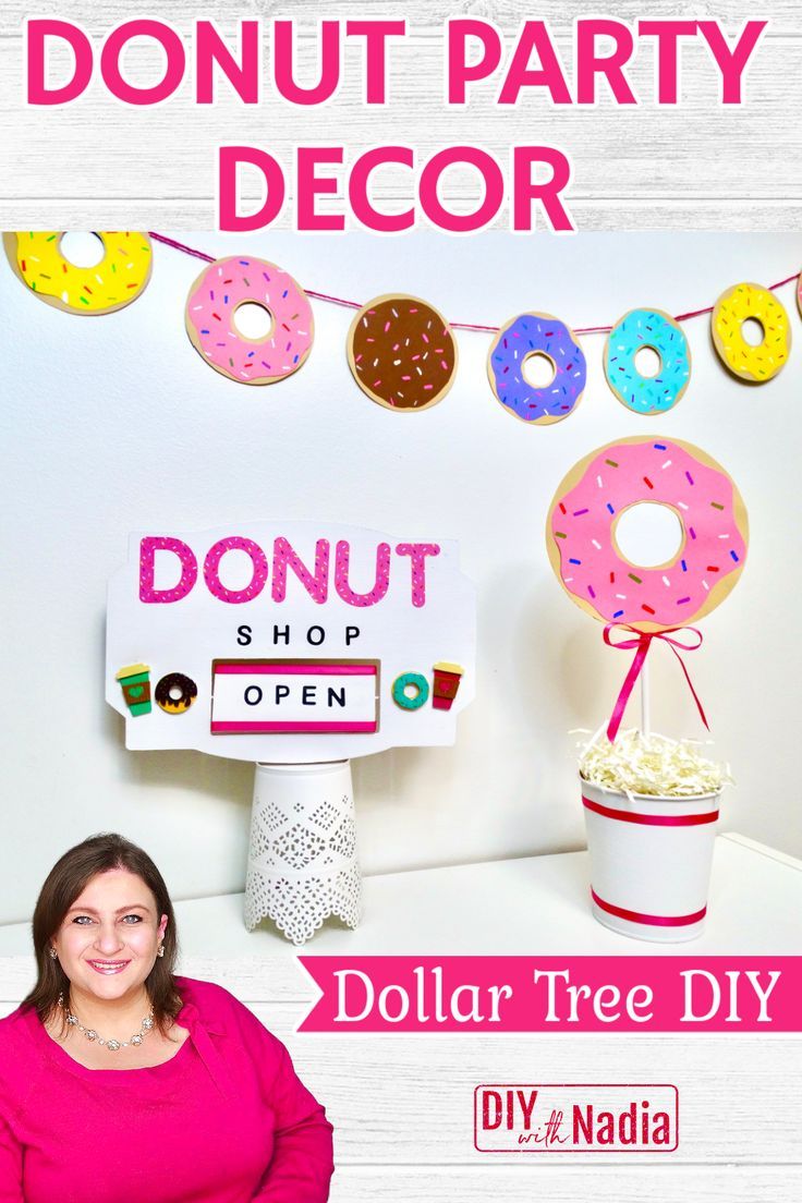 a woman standing in front of a donut shop sign with doughnuts on it