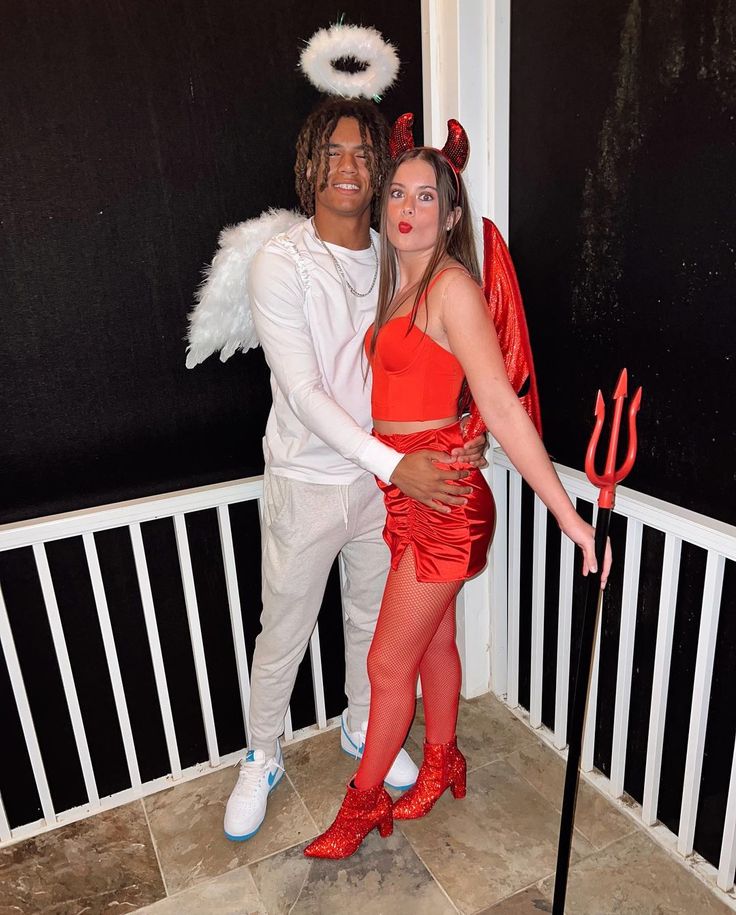 a man and woman dressed up as devil and demon