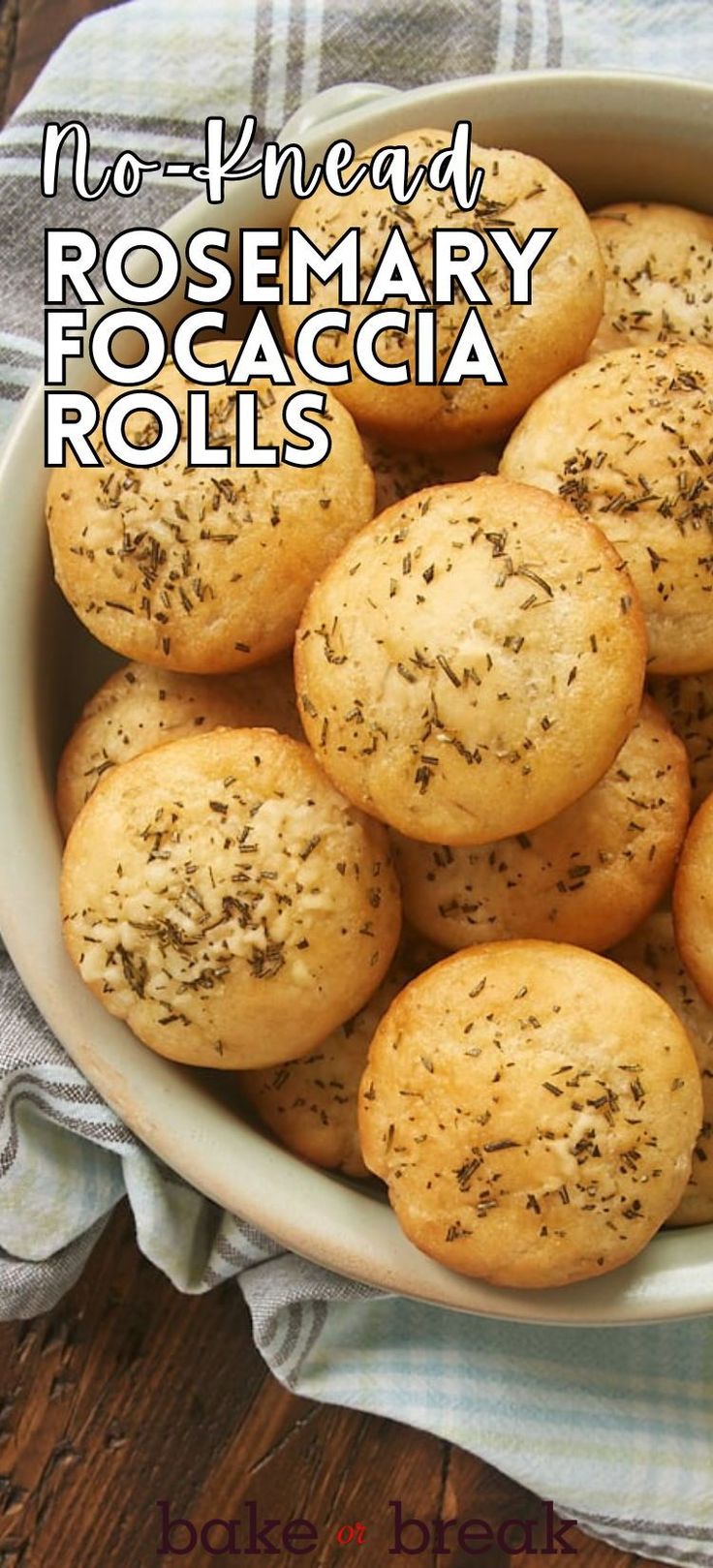 a white bowl filled with rosemary focaccia rolls