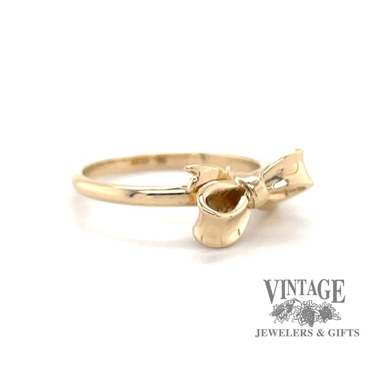 An estate 14 karat yellow gold small bow ribbon design ring. The ring is finger size 3.75. Elegant 14k Gold Butterfly Ring For Anniversary, 14k Gold Bow Jewelry, Gold Rings With Bow For Formal Occasion, Yellow Gold Bow Jewelry For Wedding, Formal Gold Rings With Bow Detail, Yellow Gold Wedding Jewelry With Bow, Formal 14k Gold Butterfly Ring, Yellow Gold Bow Jewelry For Anniversary, Yellow Gold Bow Jewelry For Formal Occasions