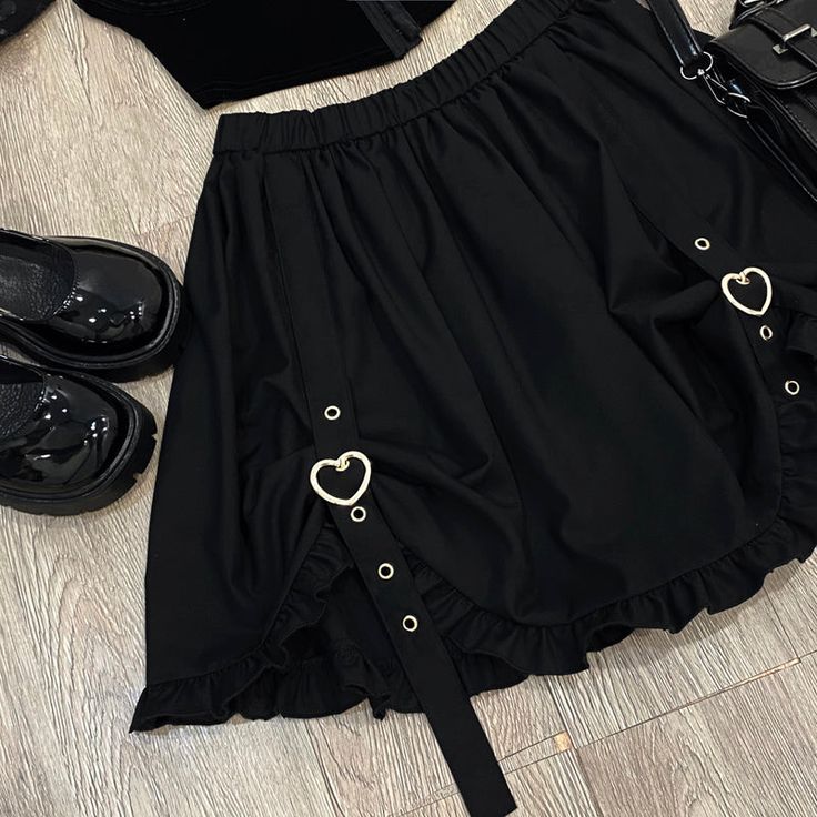 Buckle up with this Heart Buckle Skirt! Size Chart: Size Waist (cm) Length (cm) Waist (in) Length (in) One Size 62-86 45 24.41-33.86 17.72 Description: Silhouette: AsymmetricalMaterial: Cotton/SpandexDecoration: ButtonOrigin: CN(Origin)Waistline: EmpirePattern Type: SolidDresses Length: Above Knee, MiniFabric Type: BroadclothSkirt length: Short Skirt Gothic Skort For Spring, Cute Black Summer Skort, Cute Black Skort For Summer, Cute Black Summer Skirt, Gothic Mini Skirt For Spring, Spring Gothic Mini Skirt, Cute Black Party Skirt, Cute Black Bottoms For Party, Cute Black Mini Skirt For Party