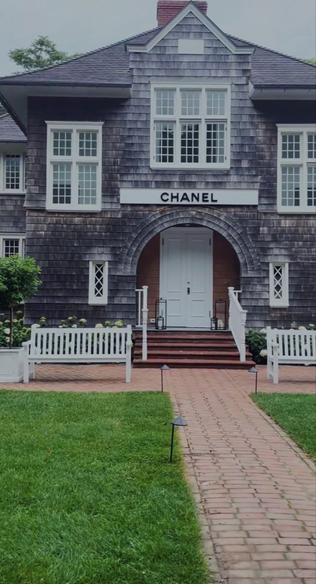 a large gray house with white trim and windows