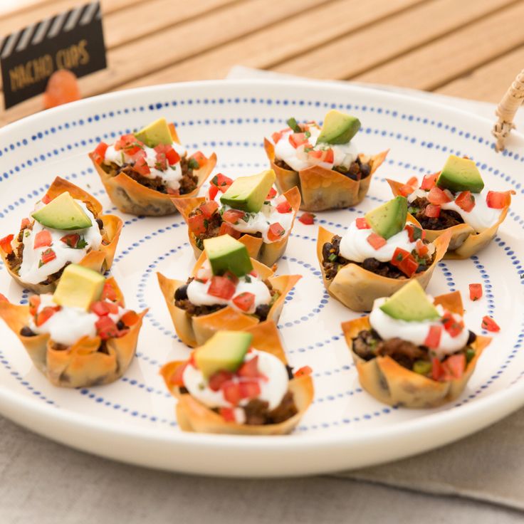 small appetizers are arranged on a blue and white plate