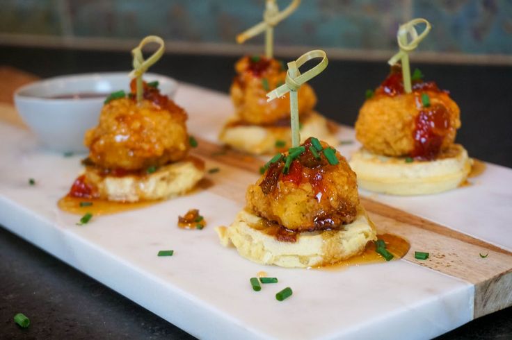 small appetizers with meatballs and sauce on a white platter, ready to be served